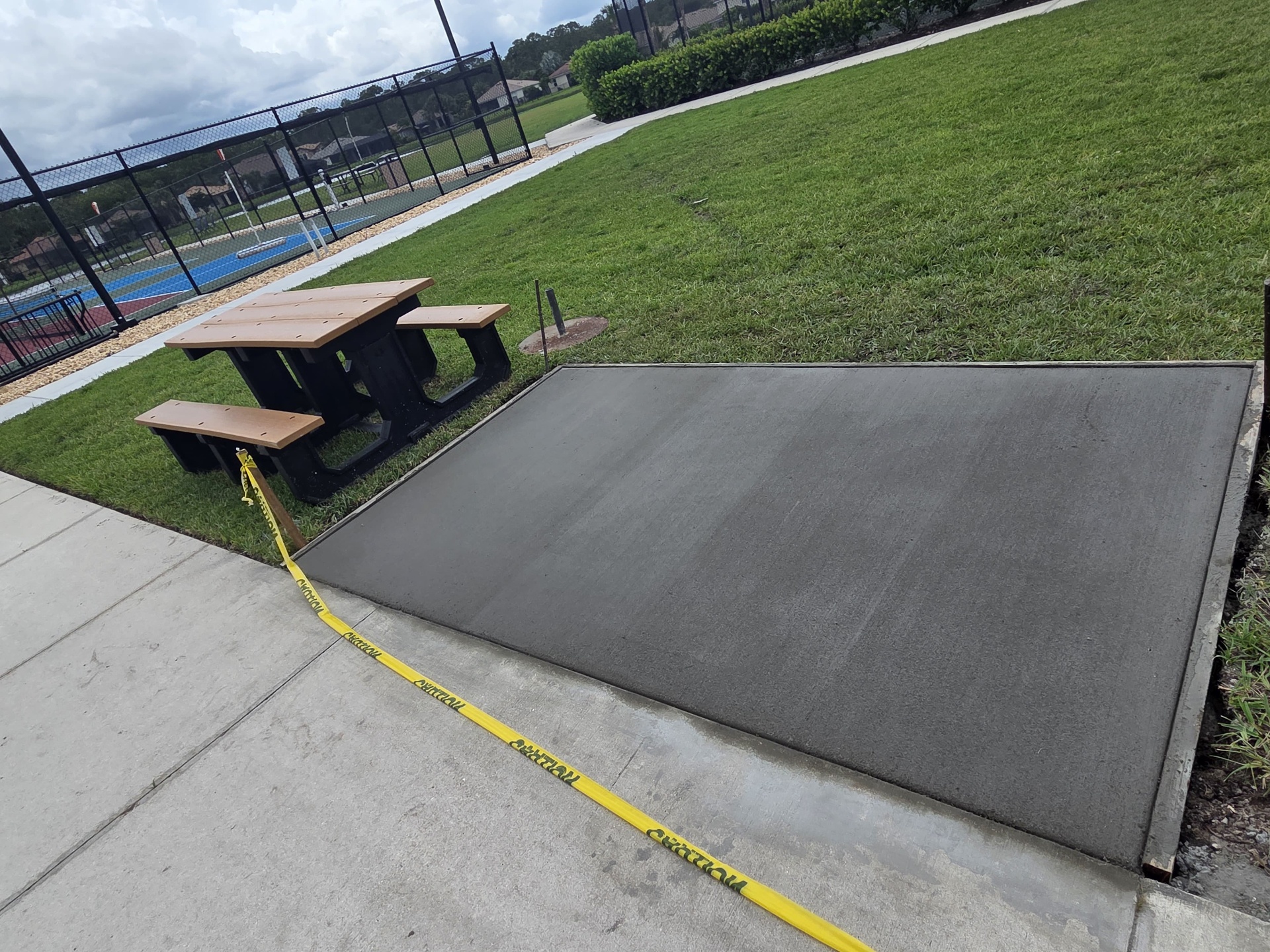 Custom concrete ramp pour at community pickleball courts