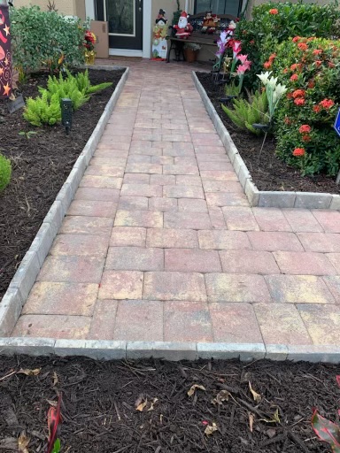 Custom paver walkway installation with garden border in Southwest Florida